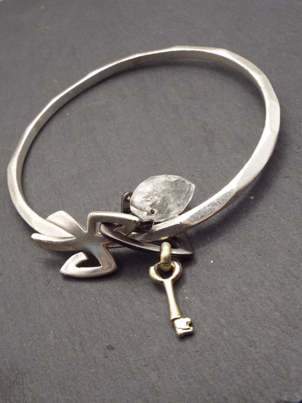 BEVELED SILVERY BANGLE W/ BOWTIE, CRYSTAL, KEY AND HEART CHARMS BRACELET M